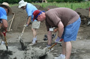 Drew and the guys mixing concrete with shovels